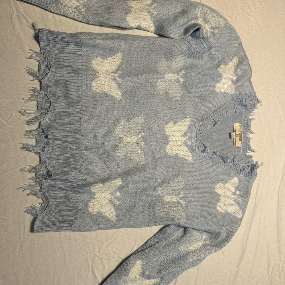 Soft sweater with butterfly design.